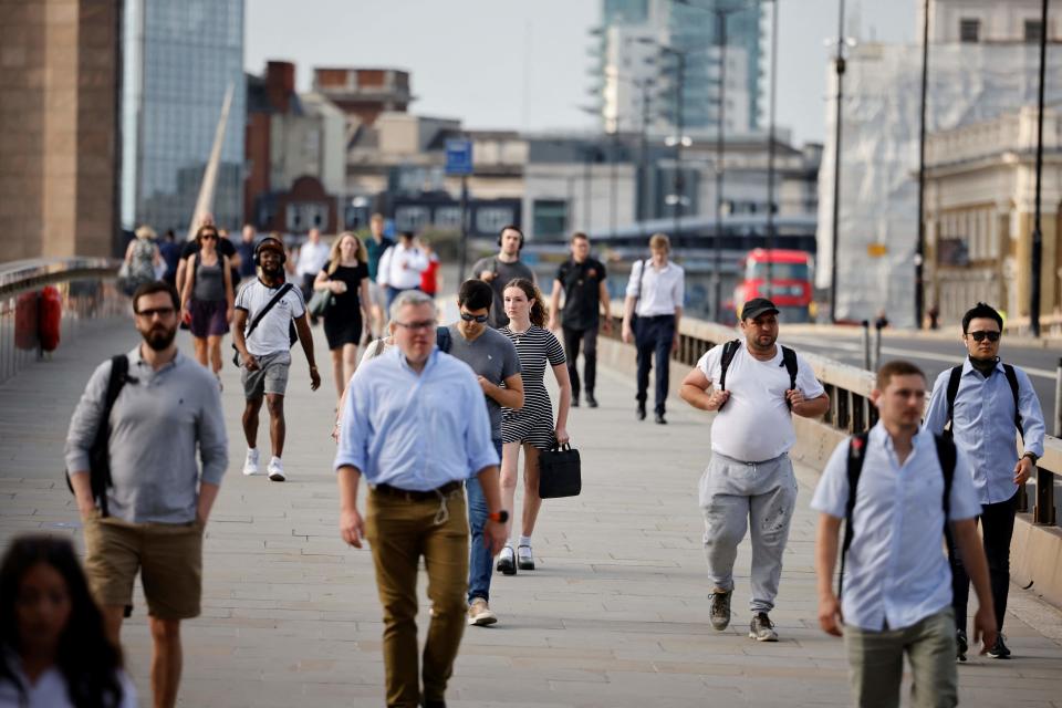 Commuters cross London Bridge in London on July 19 (AFP via Getty Images)