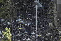 <p>Firefighters and sniffer dogs inspect debris at the foot of Grenfell Tower on June 15, 2017 in London, England. (Photo: Dan Kitwood/Getty Images) </p>