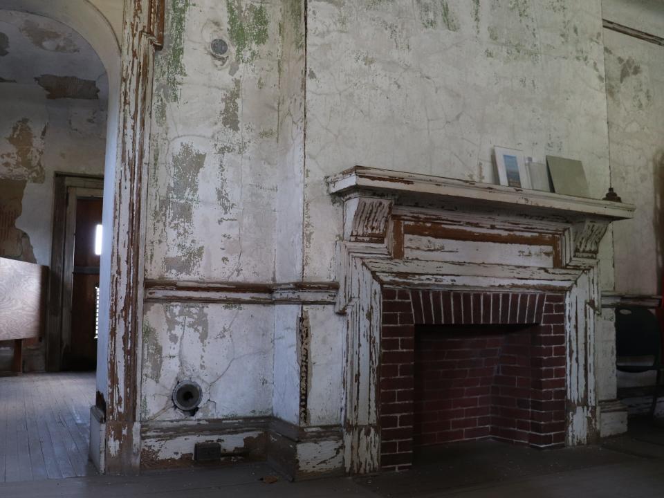living room of house on ellis island with a brick fireplace