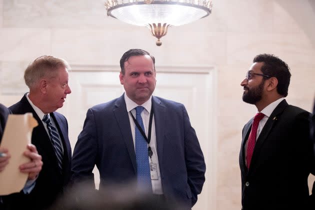 From left, Sen. Lindsey Graham R-S.C.) White House social media director Dan Scavino, and National Security Council senior director of counterterrorism Kashyap 'Kash' Pramod Patel, speak outside the Diplomatic Room as President Donald Trump speaks at the White House in Washington, Sunday, Oct. 27, 2019. (Photo: via Associated Press)