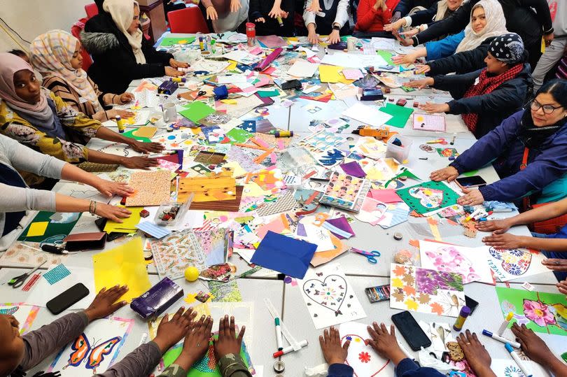 Zine participants showing their helping hands at a zine workshop (Image: Asylum Link Merseyside)