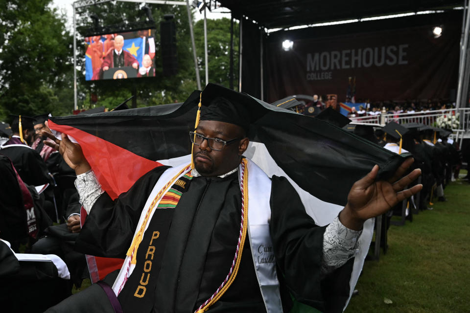 A graduating student holds a Palestinian flag as he turns his back on U.S. President Joe Biden as he delivers a speech during the Morehouse College graduation ceremony in Atlanta, Georgia on May 19, 2024. Biden's graduation speech at Morehouse College, the university where the Late rights icon Martin Luther King, Jr. will mark his most direct engagement with students since demonstrations over Israel's war in Gaza roiled campuses across the United States.  (Photo by ANDREW CABALLERO-REYNOLDS / AFP) (Photo by ANDREW CABALLERO-REYNOLDS/AFP via Getty Images)