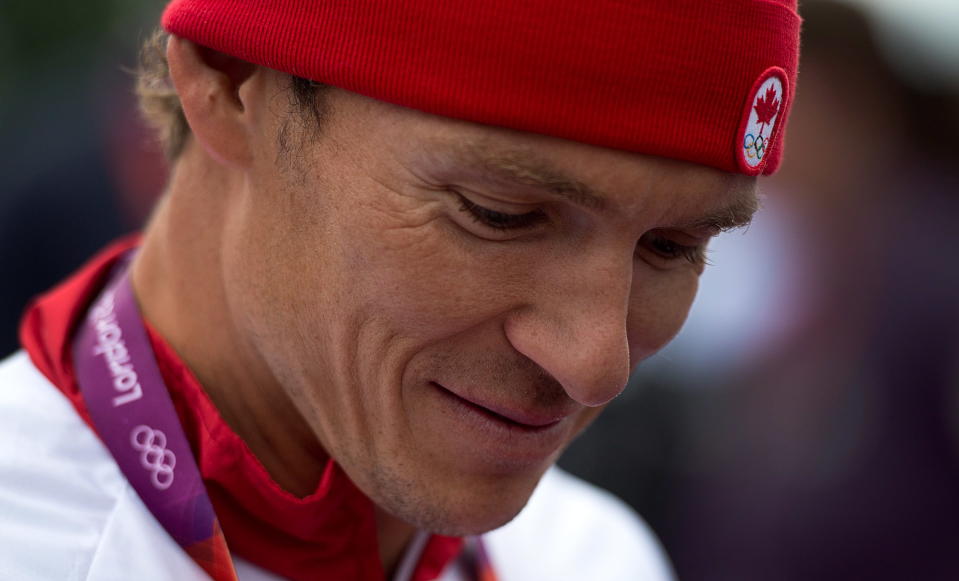 Canada's Simon Whitfield talks to reporters after crashing and retreating from the men's triathlon at Hyde Park during the Summer Olympics in London on Tuesday, August 7, 2012. THE CANADIAN PRESS/Sean Kilpatrick