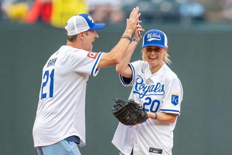 Actress Sarah Tiana, left, gets a high-five from actor James Austin Johnson after making a catch during the Big Slick celebrity softball game at Kauffman Stadium on Friday, May 31, 2024, in Kansas City.