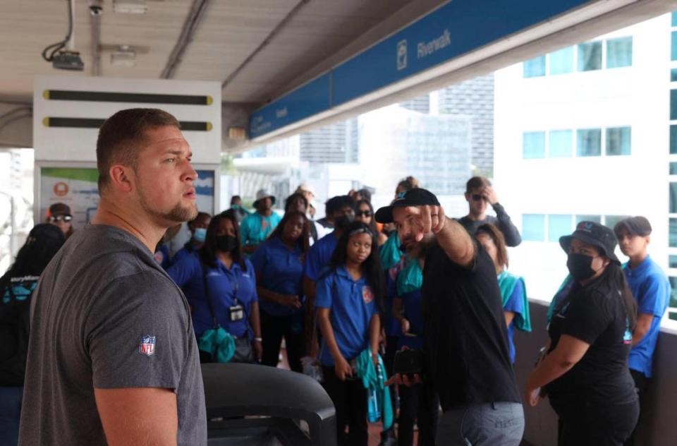 Ben Stille, a member of the Miami Dolphins rookie class, left, and youth from Miami PAL, Miami Police Athletic League, participate in a historic walking tour of Downtown Miami on Wednesday, June 15, 2022, beginning with tour leaders at the History Miami Museum.