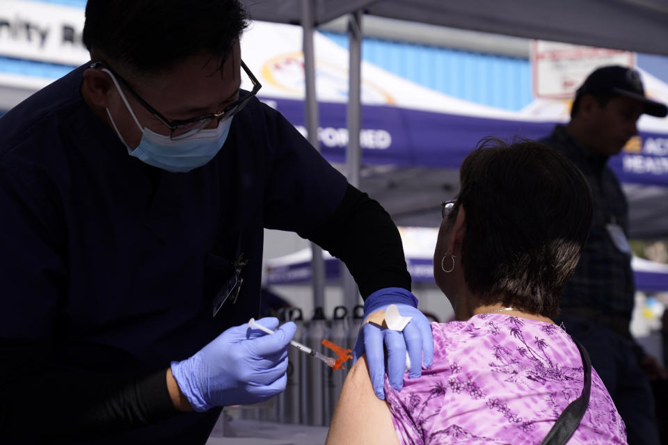 FILE - A nurse gives a flu vaccination on Oct. 28, 2022, in Lynwood, Calif. On Thursday, the Commerce Department issues its first of three estimates of how the U.S. economy performed in the third quarter of 2023. (AP Photo/Mark J. Terrill, File)