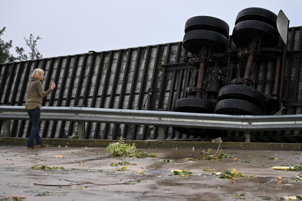 A semi-trailer lies on its side after it overturned during the storm in Trevose, Pa. Thursday, July 29, 2021. Five people were injured Thursday when a building at a Bensalem auto dealership was destroyed by severe weather, authorities said. The National Weather Service confirmed two tornados touched down in Bucks County, sending trees falling and debris flying.(Tom Gralish/The Philadelphia Inquirer via AP)