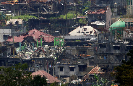 Damaged buildings and houses are seen as government troops continue their assault on its 105th day of clearing operations against pro-IS militants who have seized control of large parts of Marawi city, southern Philippines September 4, 2017. REUTERS/Romeo Ranoco