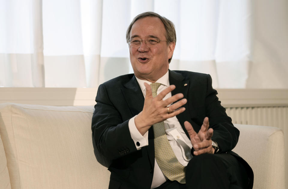 Governor of North Rhine-Westphalia Armin Laschet gestures as he speaks during an interview with the Associated Press in his office in Duesseldorf, Germany, Wednesday, June 30, 2021. Laschet, the 60-year-old governor of Germany's most populous state, is the front-runner to succeed Angela Merkel as chancellor in the country's Sept. 26 election. (AP Photo/Martin Meissner)