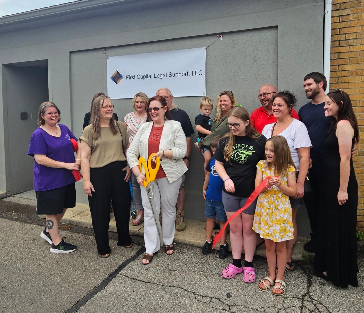 Those at First Capital Legal Support cut the ribbon celebrating the opening of its new visitation center.