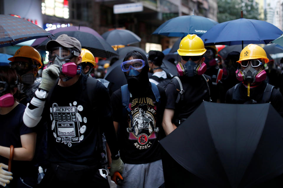 Masked protesters hold umbrellas during an anti-government rally in central Hong Kong, China October 6, 2019. REUTERS/Jorge Silva