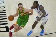 Denver Nuggets forward Paul Millsap (4) guards Utah Jazz forward Bojan Bogdanovic (44) during the first half of an NBA basketball game Friday, May 7, 2021, in Salt Lake City. (AP Photo/Rick Bowmer)