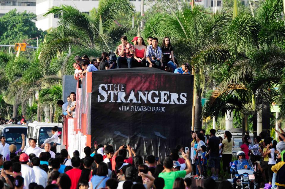 The float of the MMFF 2012 entry "The Strangers" makes its way through the crowd at the 2012 Metro Manila Film Festival Parade of Stars starting on 23 December 2012. (Angela Galia/NPPA Images)