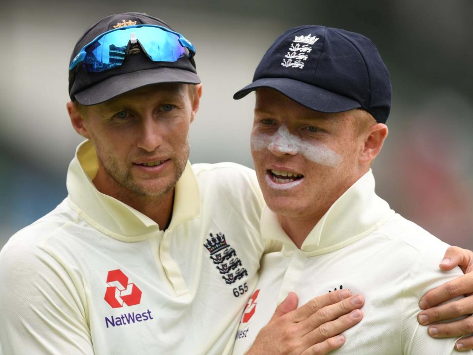 Ollie Pope is congratulated by England captain Joe Root: Getty