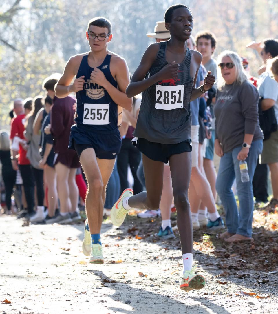 Sixth-place finisher Delaware Military's Troy Hedrick (left) and seventh placer Chris Onsomu of St. Andrews run in the DIAA 2022 Cross Country Boy’s Division II Championship at Killens Pond State Park in Felton, Del.