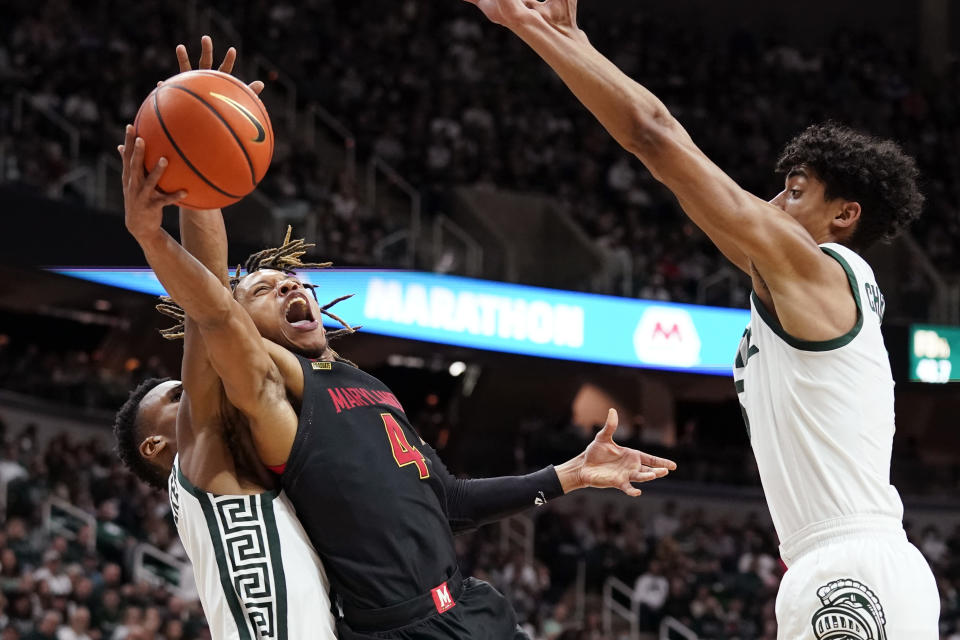 Maryland guard Fatts Russell (4) is defended by Michigan State guard Tyson Walker left, during the first half of an NCAA college basketball game, Sunday, March 6, 2022, in East Lansing, Mich. (AP Photo/Carlos Osorio)