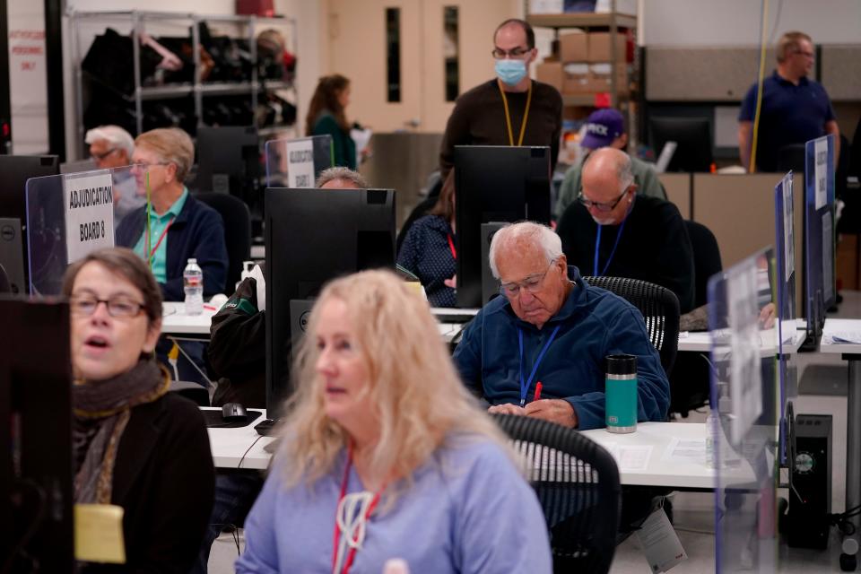 Election adjudicators observe ballot tabulation inside the Maricopa County Recorders Office on Thursday in Phoenix.