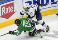 Tampa Bay Lightning's Anthony Cirelli (71) checks Dallas Stars' Mattias Janmark (13) during the third period of an NHL Stanley Cup finals hockey game in Edmonton, Alberta, on Monday, Sept. 28, 2020. (Jason Franson/The Canadian Press via AP)