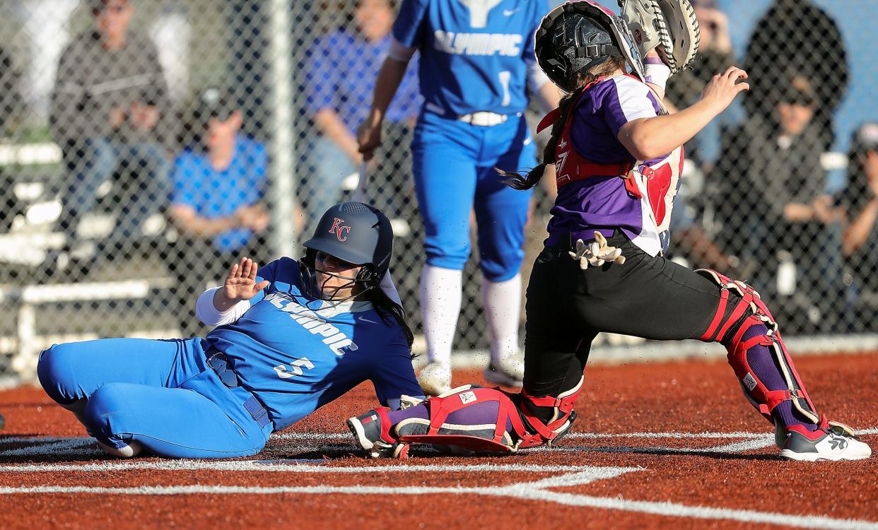 Olympic's Ros Tate (5) slides into home ahead of the catch by North Kitsap's Mackenzie Phillips at Gene Lobe Field on March 22. The Trojans won 5-0, and the Vikings won a rematch later in the season, 3-2. The two teams, both 14-4, pair off in the opening round of district play on Friday.