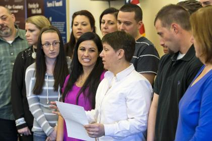 Lesa Strachan, in white shirt, reads a statement after the conviction of Aaron Hernandez. (AP)