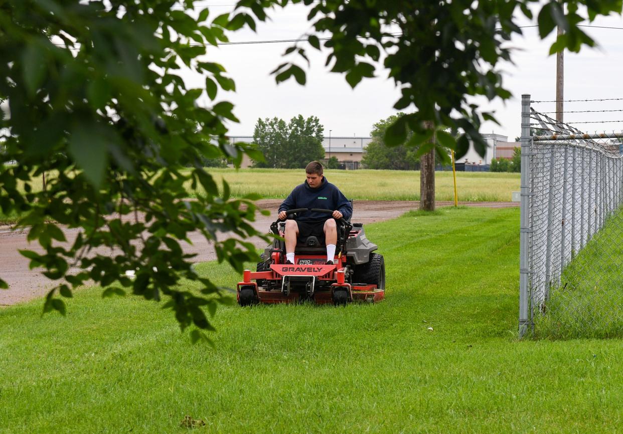 Tyler Arrowood mows a lawn on N Third Avenue on Wednesday, June 15, 2022, in Sioux Falls.