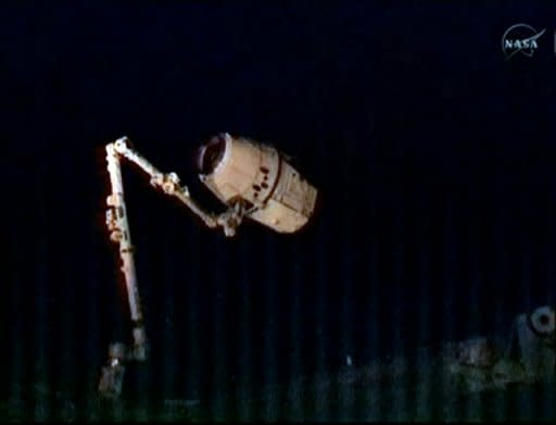 In this frame grab from a NASA video, the robotic arm (bottom L) of the International Space Station captures the SpaceX Dragon capsule on May 25. SpaceX became the first commercial outfit to send its own cargo capsule to the International Space Station, heralding the start of a new era for private spaceflight