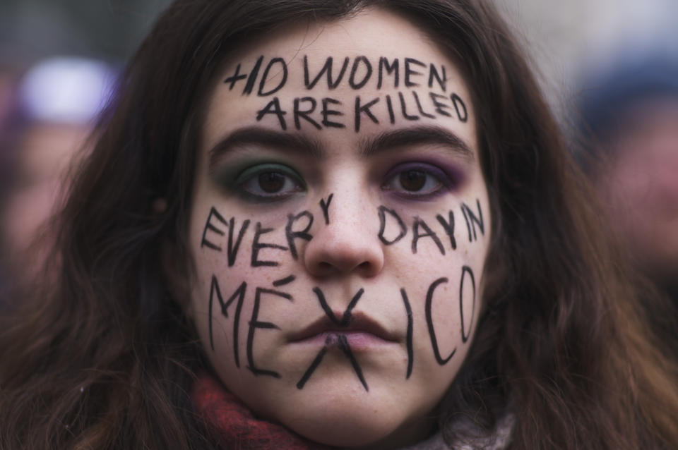 A woman from Mexico with a message draw in her face about the situation in her home country attends a rally marking International Women's Day 2023 in Berlin, Germany, Wednesday, March 8, 2023. (AP Photo/Markus Schreiber)