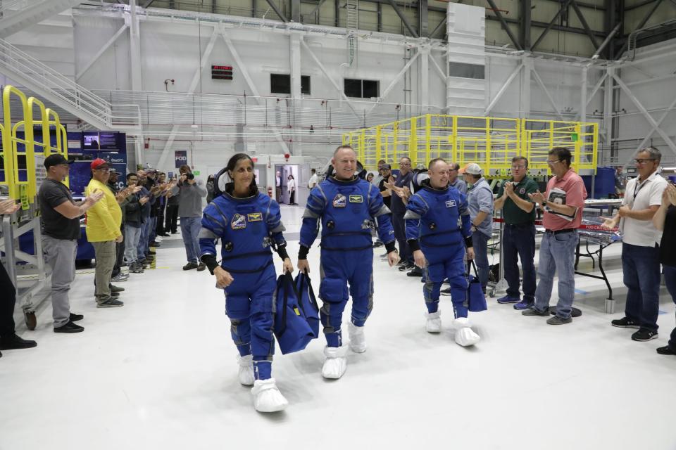 The NASA astronauts for Boeing’s Crew Flight Test (CFT) arrive in the high bay of Boeing’s Commercial Crew and Cargo Processing Facility at NASA’s Kennedy Space Center in Florida on Oct. 18, 2022. From left are Suni Williams, pilot; Barry “Butch” Wilmore, commander; and Mike Fincke, CFT backup spacecraft test pilot.