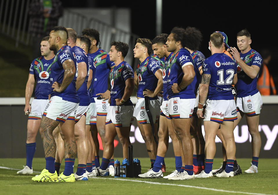 Pictured here, Warriors players stand together during an NRL game in 2021.