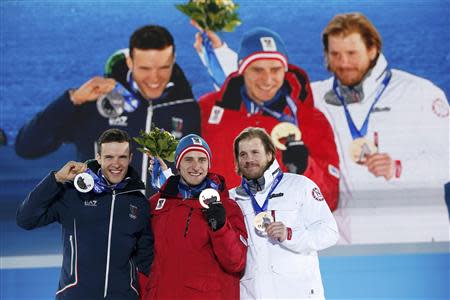 Gold medalist Matthias Mayer of Austria (C). silver medalist Christof Innerhofer of Italy (L), and bronze medalist Kjetil Jansrud of Norway pose during the medal ceremony for the men's alpine skiing downhill race in the Olympic Plaza at the 2014 Sochi Winter Olympics February 9, 2014. REUTERS/Marko Djurica