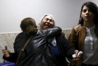 A woman is comforted by another at a hospital morgue where killed Bar Association President Tahir Elci is brought for an autopsy in Kurdish dominated southeastern city of Diyarbakir, Turkey, November 28, 2015. REUTERS/Sertac Kayar