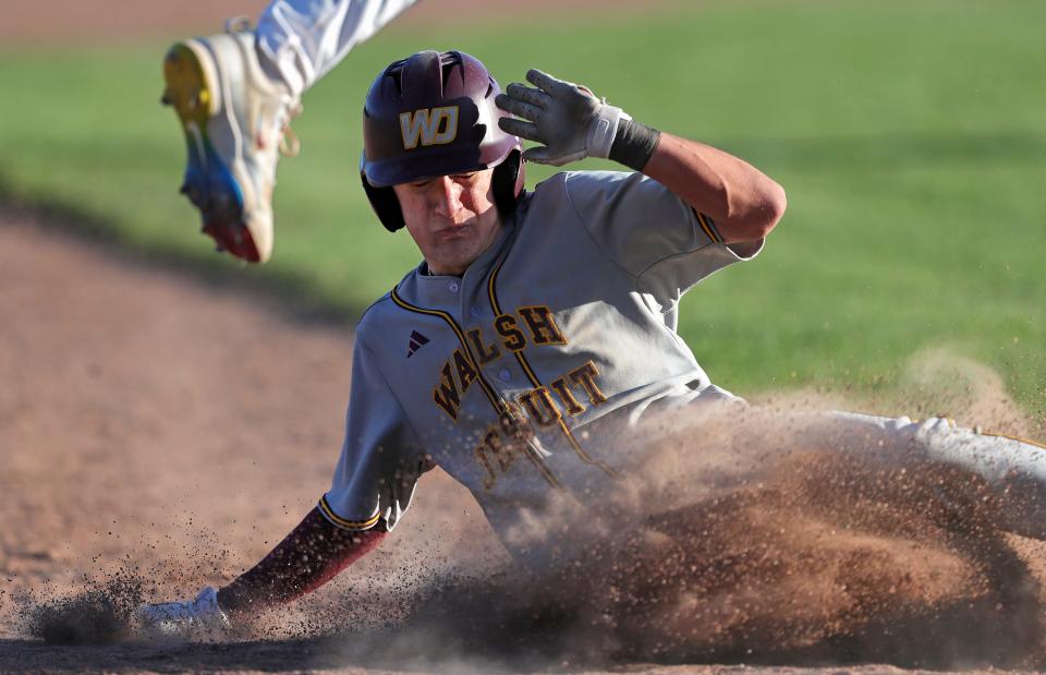 Walsh Jesuit baserunner Conner Romanini slides safely to third during the sixth inning of a high school baseball game against Padua.