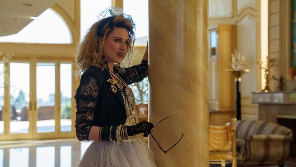 Evan Rachel Wood as Madonna holds onto a column in a house in Weird