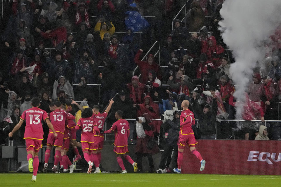 St. Louis City players celebrate after a goal byTim Parker during the first half of an MLS playoff soccer match against Sporting Kansas City Sunday, Oct. 29, 2023, in St. Louis. (AP Photo/Jeff Roberson)