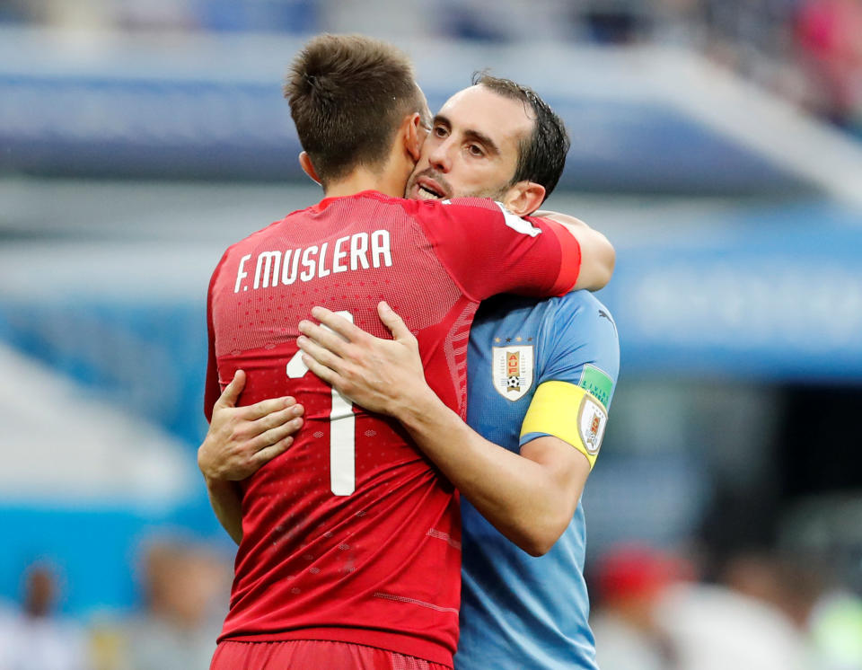 <p>Diego Godin celebrates victory with Fernando Muslera after Uruguay confirmed their place in Last 16 </p>