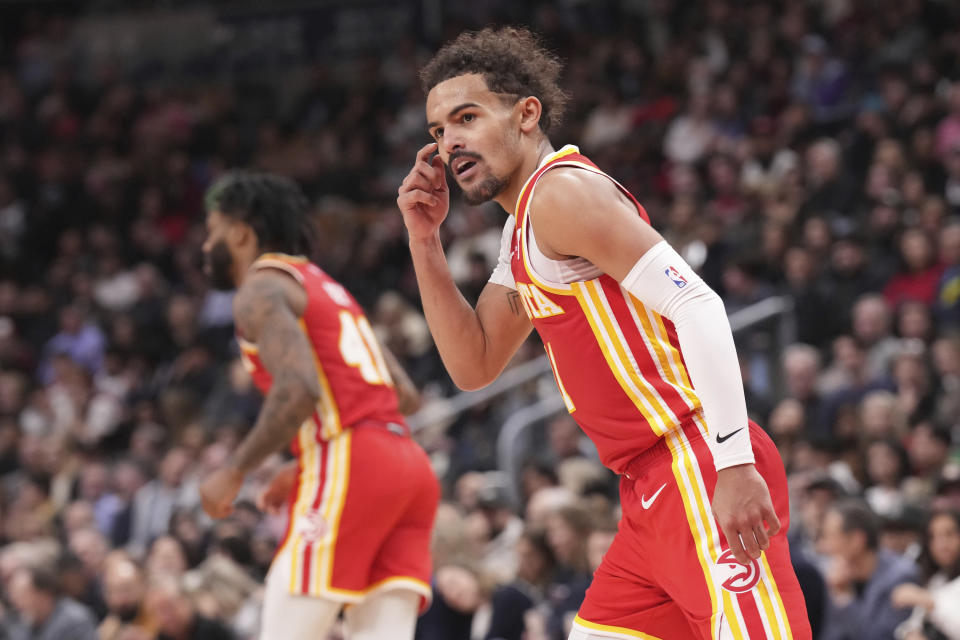 Atlanta Hawks guard Trae Young (11) reacts during his team's win over the Toronto Raptors in NBA basketball game action in Toronto, Friday, Dec. 15, 2023. (Chris Young/The Canadian Press via AP)