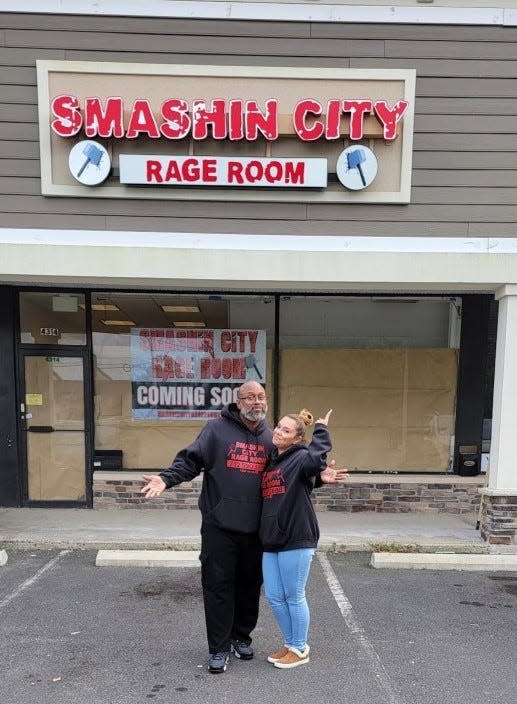 Smashin City Rage Room owners Delovi and Esther Canales in front of their Howell location before it opened in the fall of 2021.