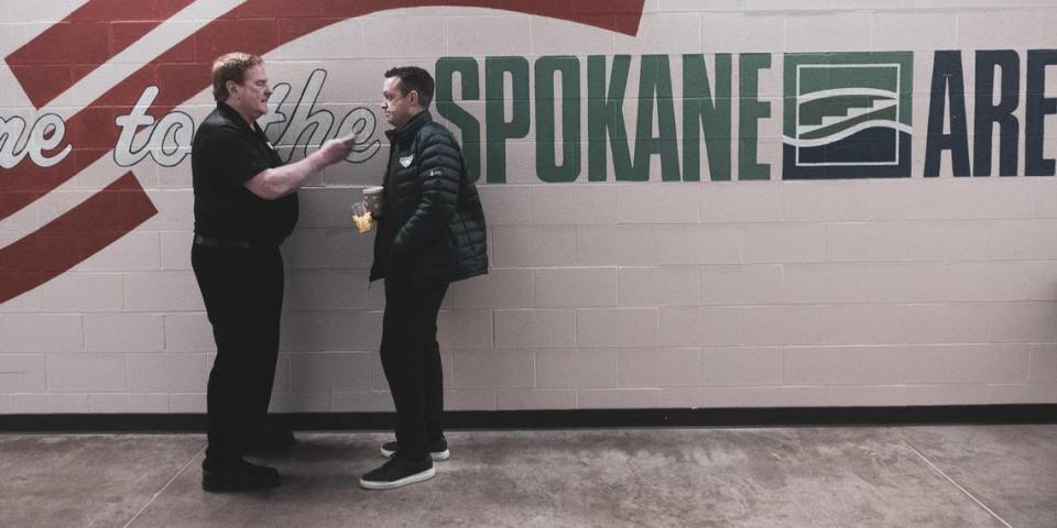 Announcer Craig West interviews head coach and former player Stu Barnes in the arena in Spokane.