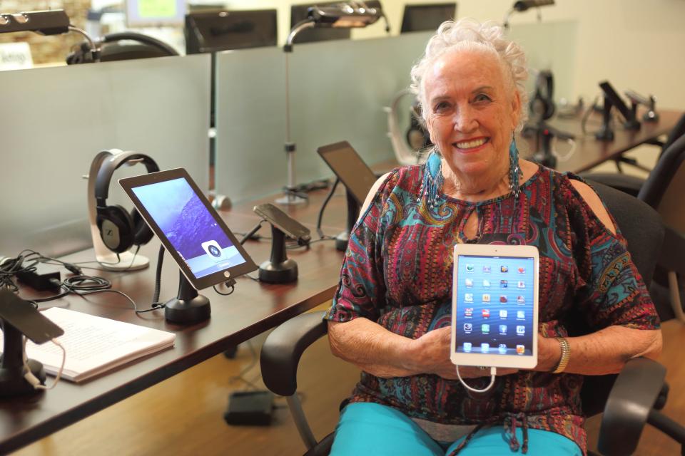 A Braille Institute technology center student shows off her tablet.