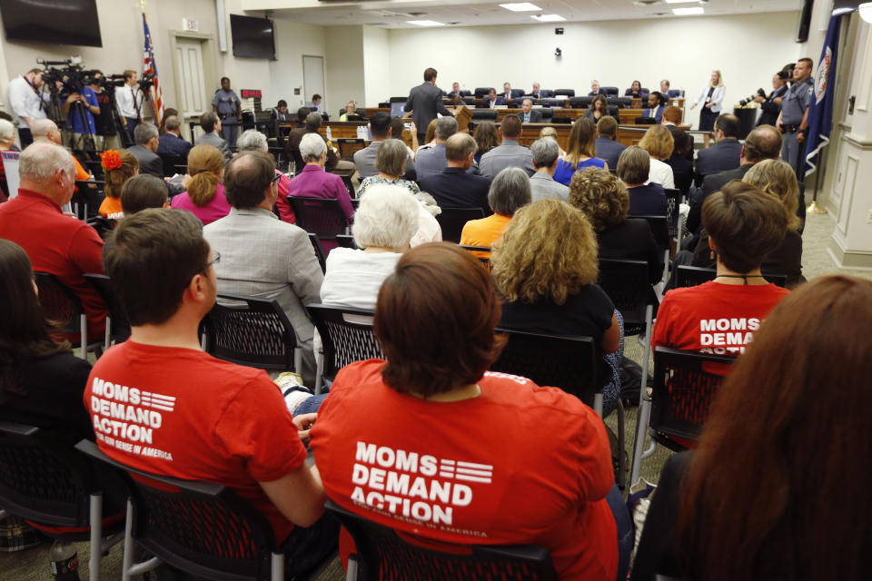 Attendees wear shirts during the second day of a Virginia Crime Commission meeting on gun issues at the Capitol in Richmond, Va., Tuesday, Aug. 20, 2019. Democratic Gov. Ralph Northam called the special session after a city employee opened fire in a Virginia Beach municipal complex May 31. (AP Photo/Steve Helber)