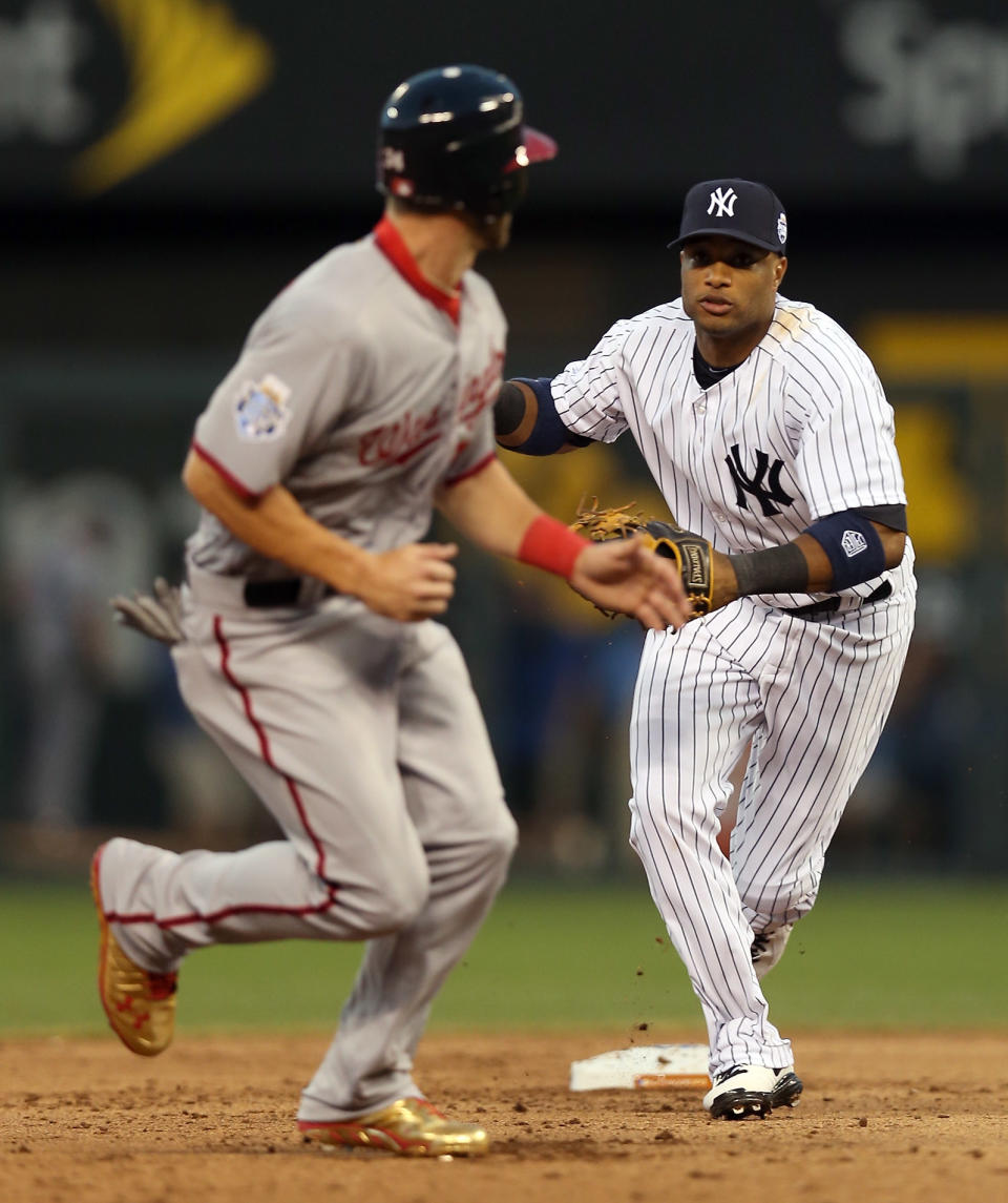 KANSAS CITY, MO - JULY 10: American League All-Star Robinson Cano #24 of the New York Yankees runs after National League All-Star Bryce Harper #34 of the Washington Nationals in the fifth inning during the 83rd MLB All-Star Game at Kauffman Stadium on July 10, 2012 in Kansas City, Missouri. (Photo by Jonathan Daniel/Getty Images)