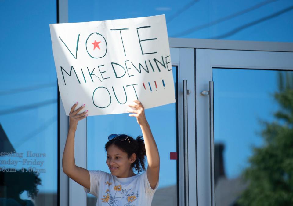 Students for a Democratic Society organized a protest in support of reproductive rights after the Supreme Court decision to overturn Roe v. Wade. Sydney Brown holds a sign on the front steps of the Kent Courthouse.