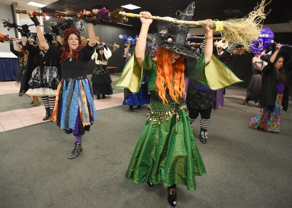 Cathy Songalewski of Ida and Helen Harrigan of Monroe, members of the Lake Eerie Hexenbrut, start to rehearse the witch dance with other members April 30 inside the Players Club at the Mall of Monroe.