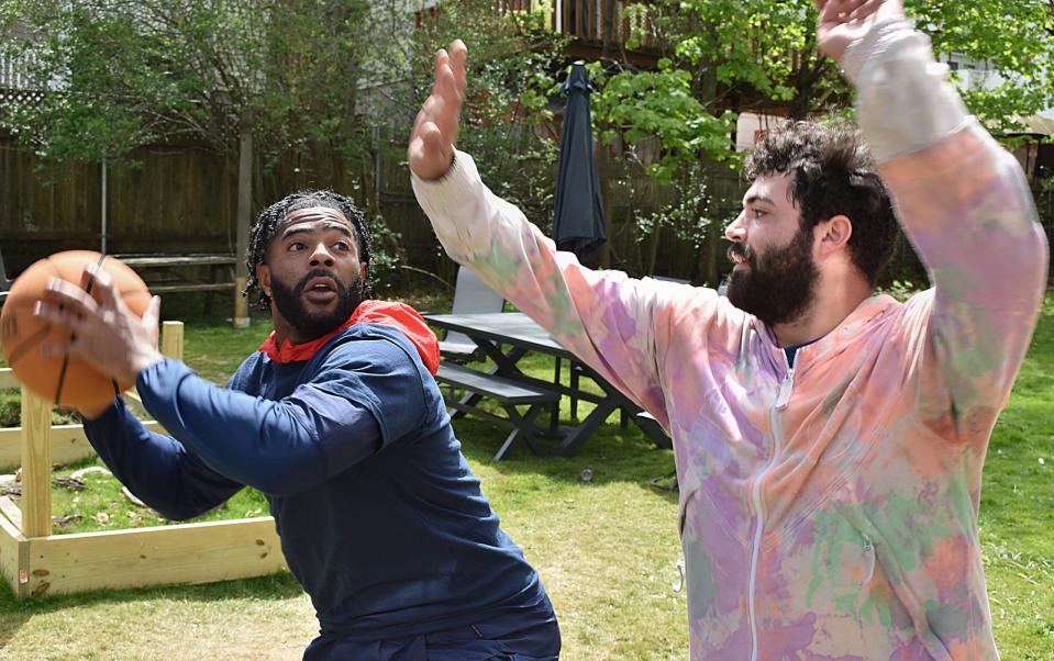 Patriots player Malcolm Butler goes one-on-one with resident Layne Vieira at the ribbon cutting for the renovated DCF house for young adults in Fall River, Wednesday, May 11.