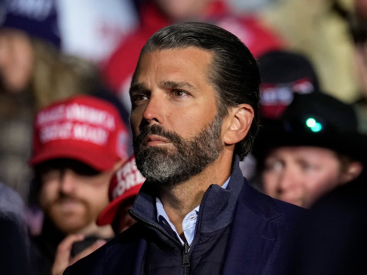 Donald Trump Jr. listens as former President Donald Trump speaks at a rally at the Dayton International Airport on November 7, 2022 in Vandalia, Ohio (Getty Images)