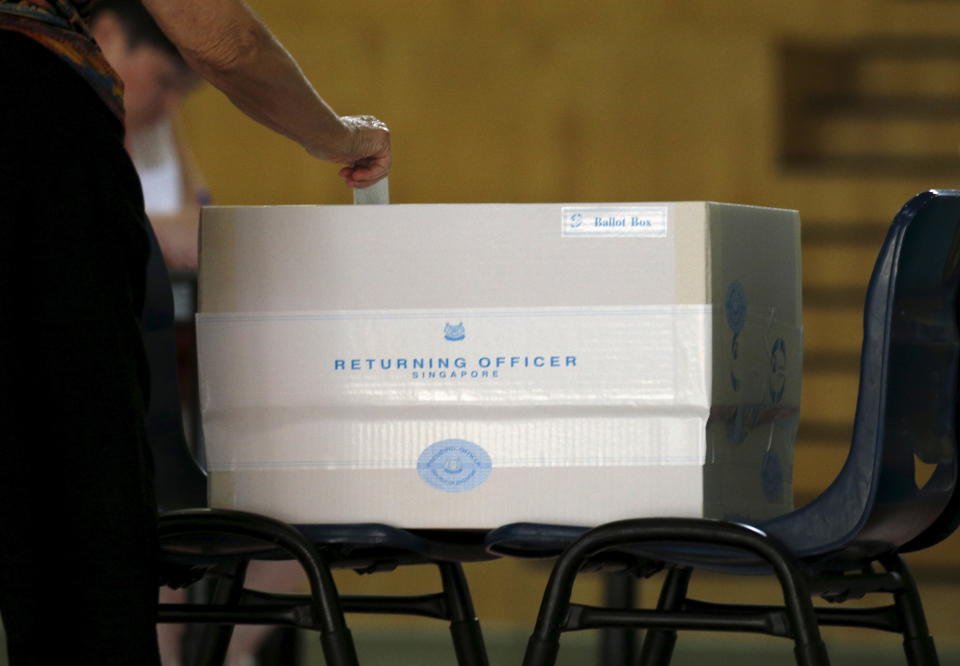 A voter casts his ballot during the general election at a polling center in Singapore September 11, 2015. Singaporeans go to the polls on Friday for the city-state's most hotly contested general election, which could bring the sternest test of the long-ruling party's dominance of politics even though it is bound to win. REUTERS/Edgar Su 