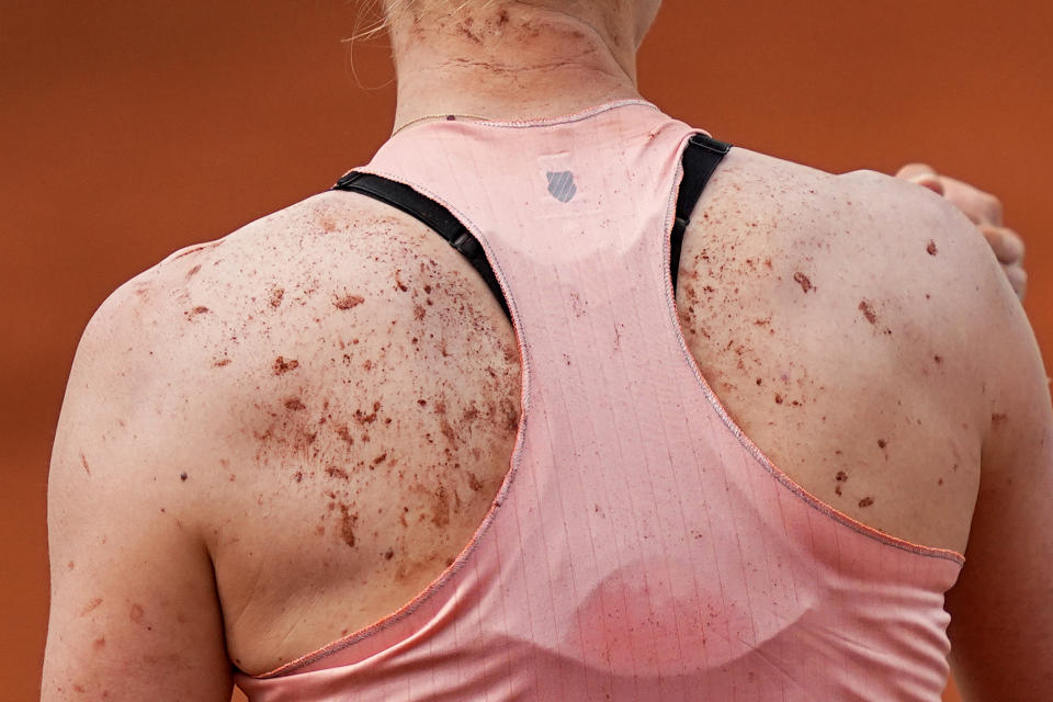 USA's Alison Riske' back is spotted with clay after her second round match of the French Open tennis tournament against Poland's Iga Swiatek, at the Roland Garros stadium Thursday, May 26, 2022 in Paris. Swiatek won 6-0, 6-2. (AP Photo/Michel Euler)