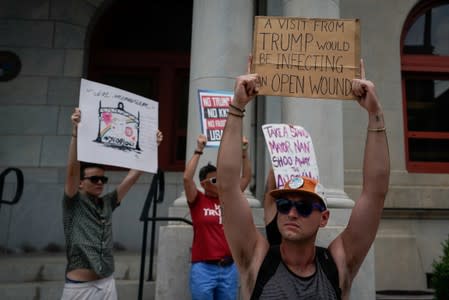 A small group of protesters gather at city hall in opposition to U.S. President Donald Trump visit to Dayton following a mass shooting in Dayton