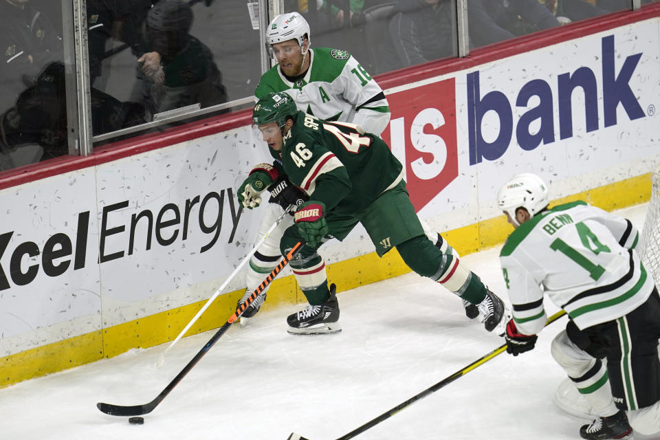 Minnesota Wild defenseman Jared Spurgeon (46) and Dallas Stars center Joe Pavelski, back, vie for the puck during the first period of an NHL hockey game Friday, Feb. 17, 2023, in St. Paul, Minn. (AP Photo/Abbie Parr)