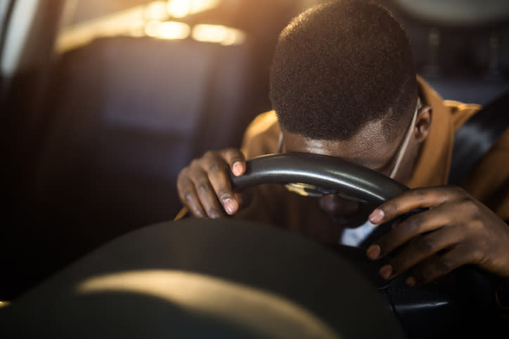 person asleep behind the wheel